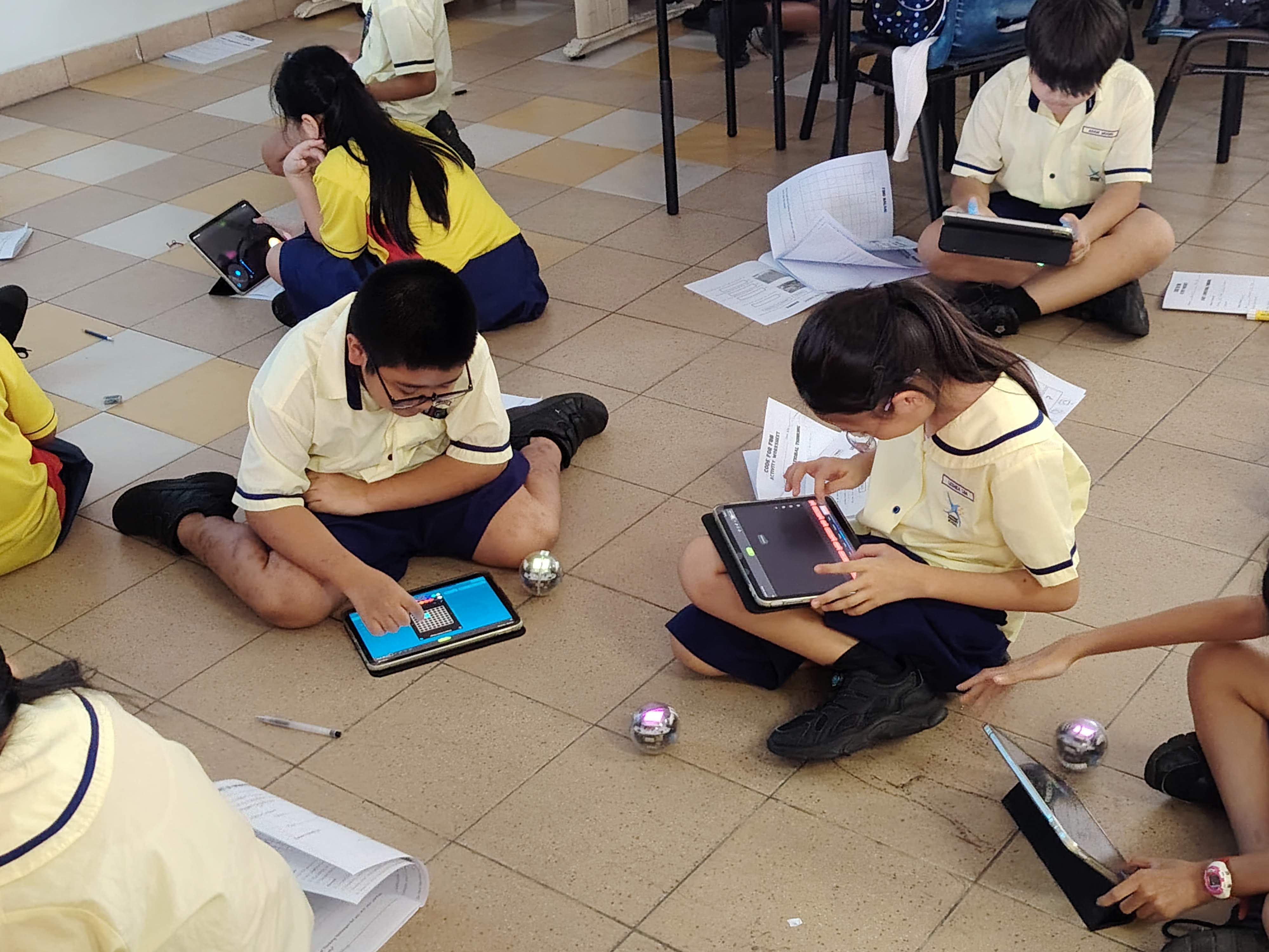 Students hard at work mastering the basics of programming their Spherobots